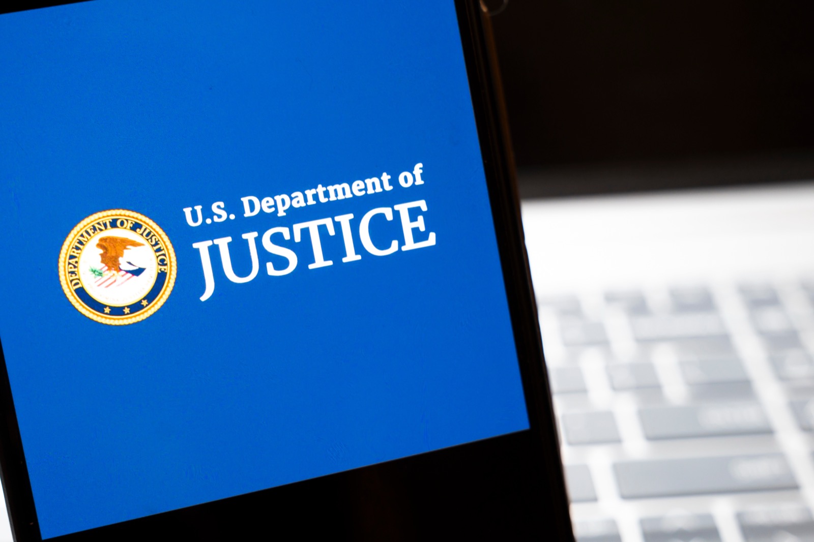 United States Department of Justice seal displayed on a screen