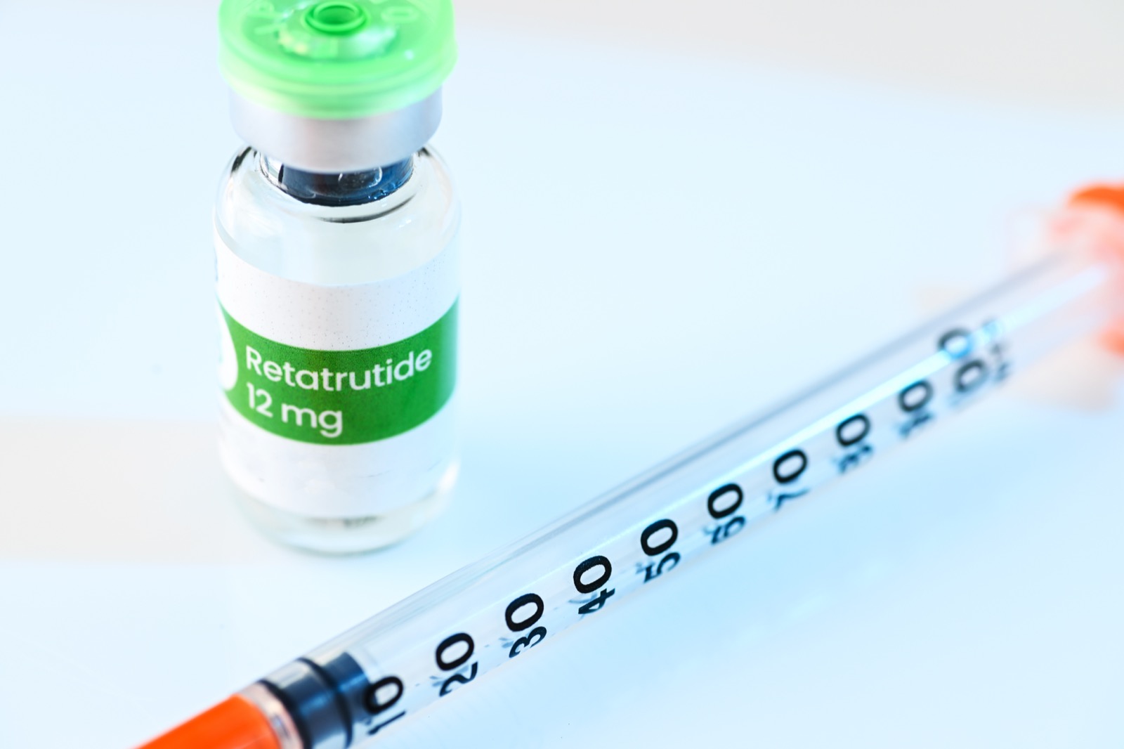 A 12mg vial of retatrutide alongside a syringe, a compound not approved for human use anywhere in the world